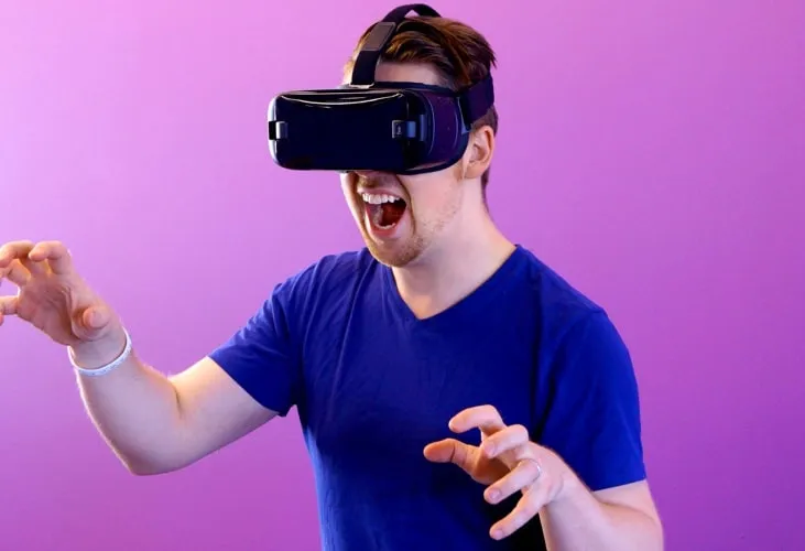 A man wearing a VR headset and enjoying it.